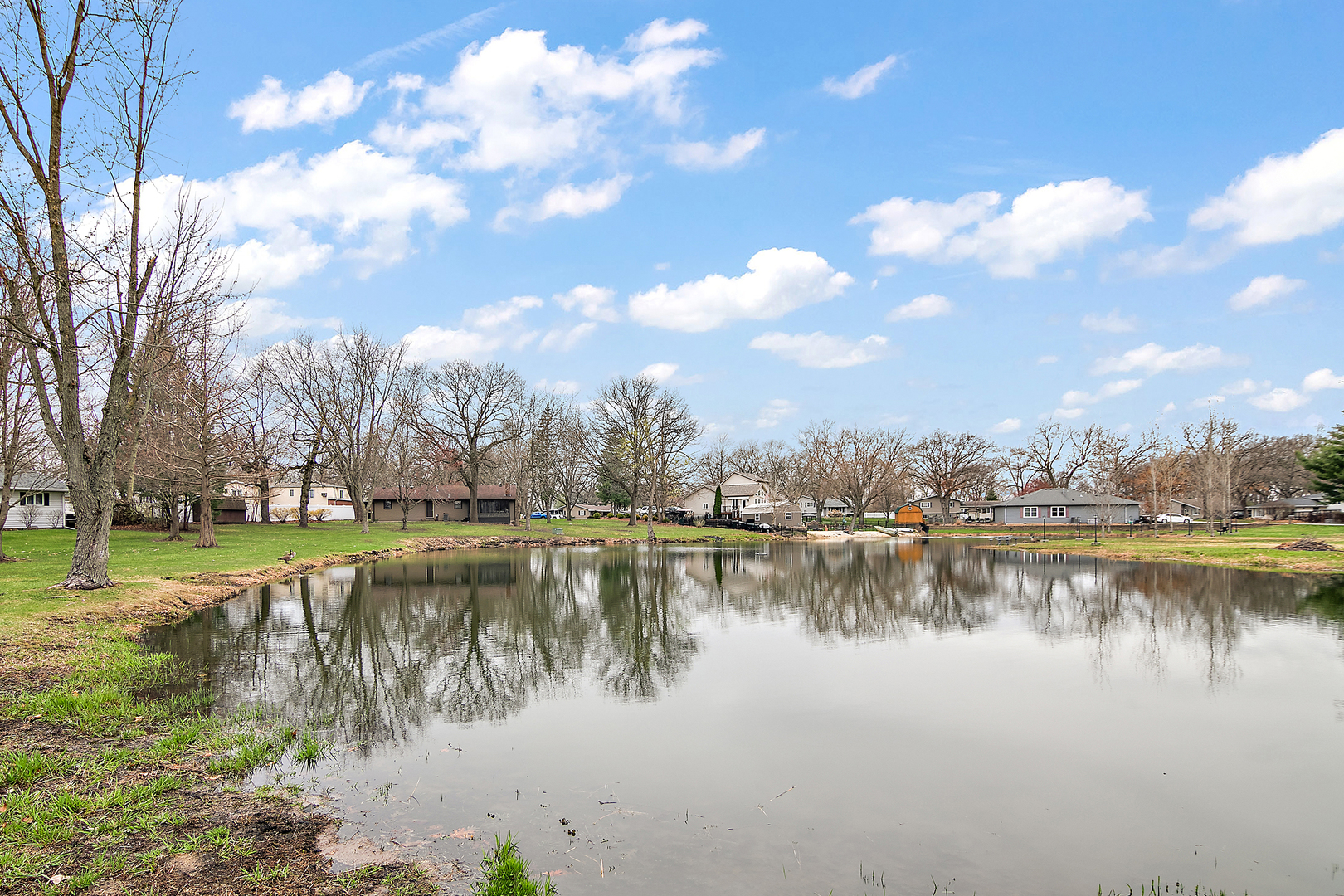 1173 Cecil Drive Kankakee, IL 60901 - Photo 19 of 32 a view of a lake with houses in the back