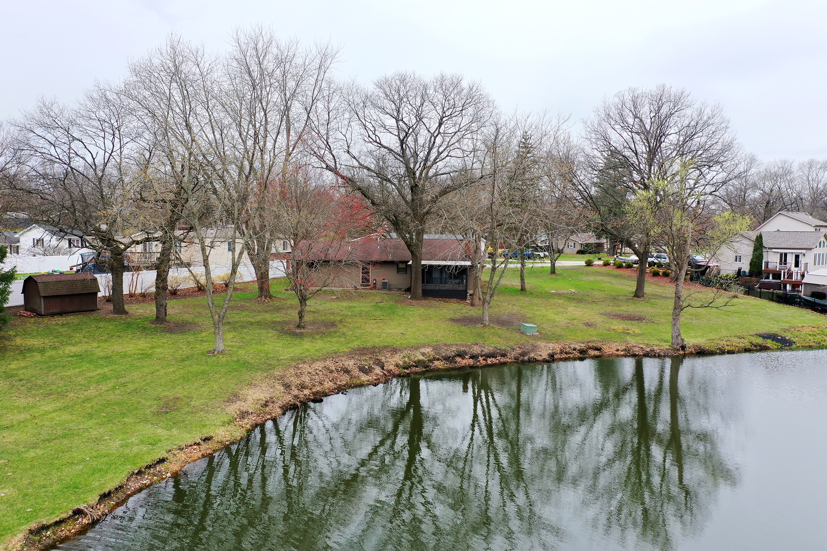 1173 Cecil Drive Kankakee, IL 60901 - Photo 27 of 32 a view of a lake with a building in the background
