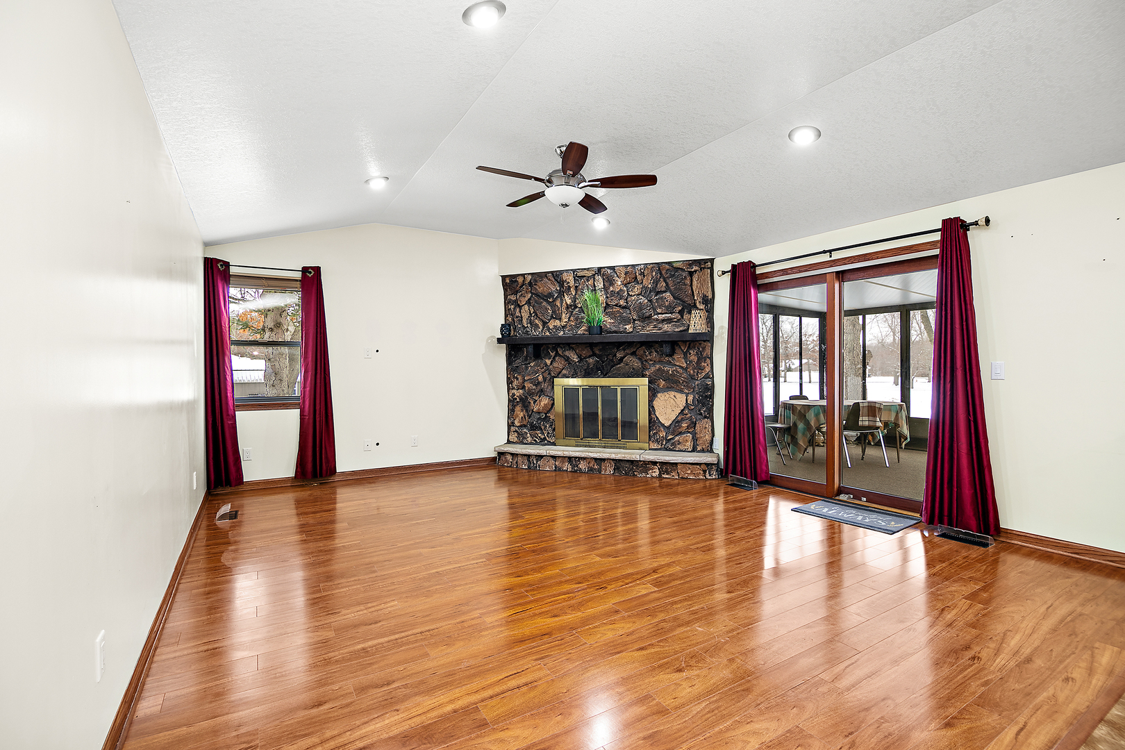 1173 Cecil Drive Kankakee, IL 60901 - Photo 6 of 32 a view of an empty room with window wooden floor and a kitchen