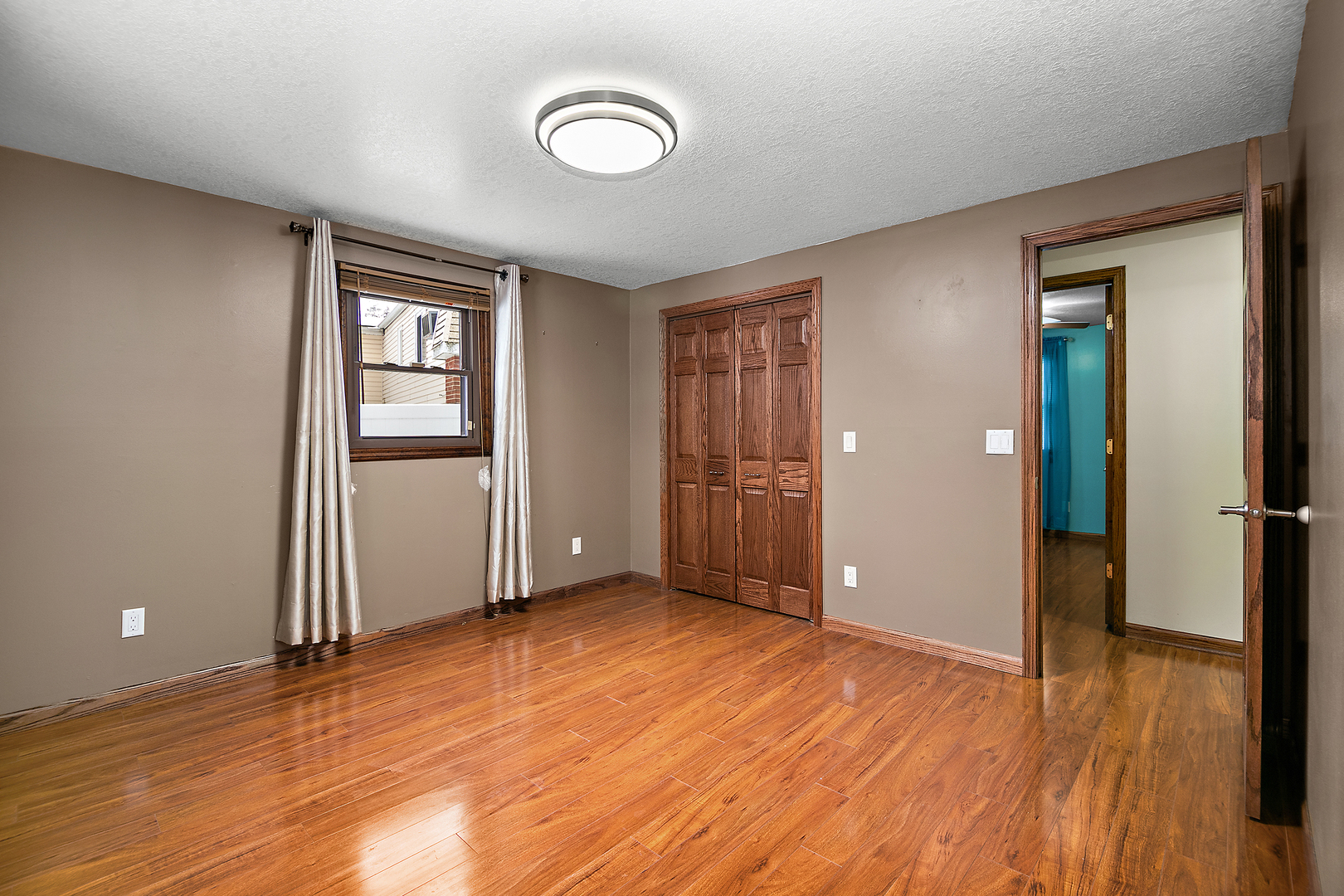 1173 Cecil Drive Kankakee, IL 60901 - Photo 9 of 32 an empty room with wooden floor and windows