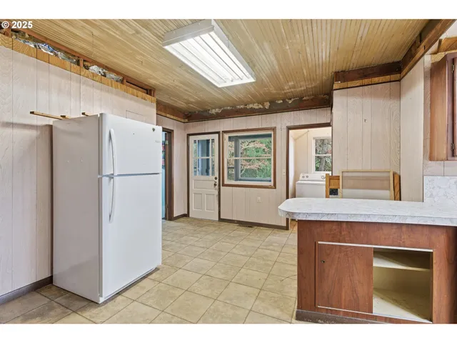 a kitchen with stainless steel appliances granite countertop a refrigerator a sink and a stove