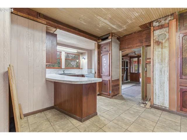 a kitchen with stainless steel appliances granite countertop a sink and a refrigerator