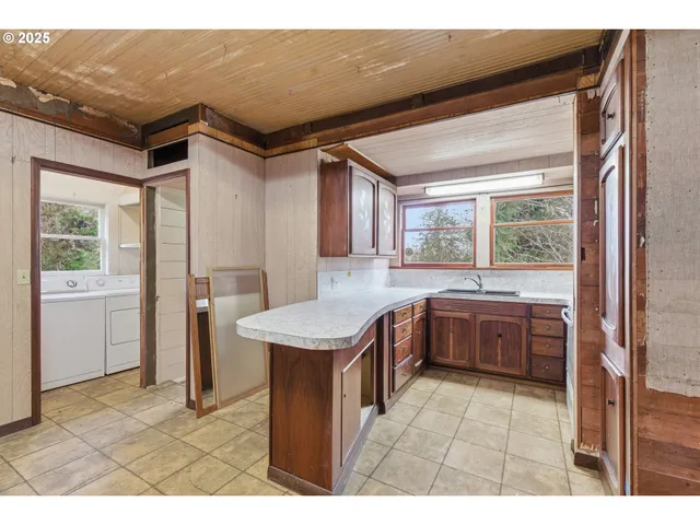 a kitchen with a stove a refrigerator and a sink