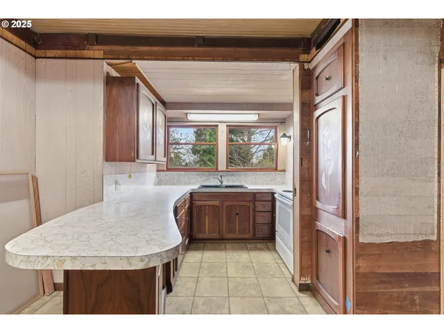 a kitchen with stainless steel appliances granite countertop a sink and a refrigerator