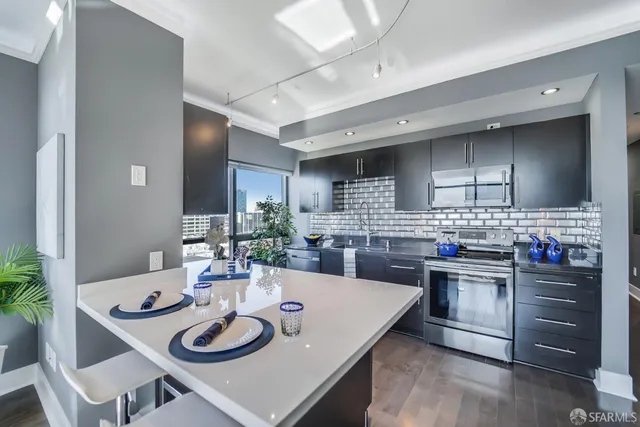 a kitchen with a table chairs stove and refrigerator