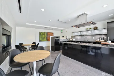 a kitchen with counter space dining table and chairs
