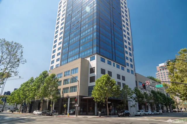 a view of a tall building next to a road