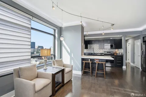 a living room with stainless steel appliances kitchen island granite countertop furniture and a kitchen view
