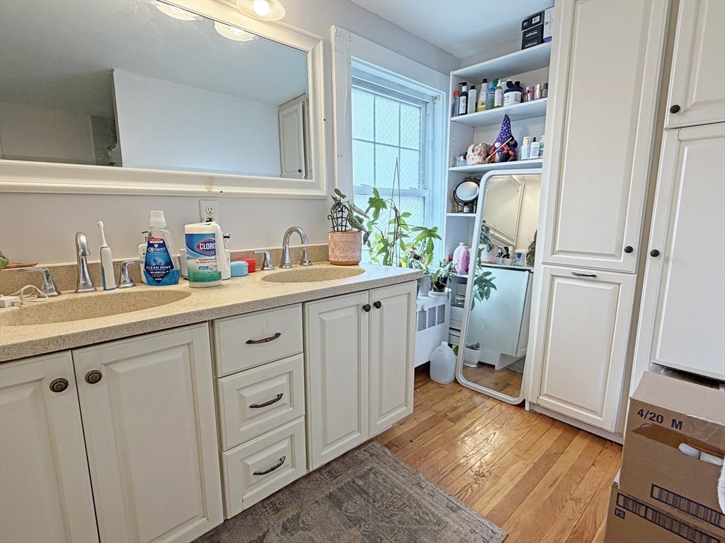 75-77 Dale Street, Unit 77 Waltham, MA 02451 - Photo 17 of 17 a kitchen with white cabinets and sink