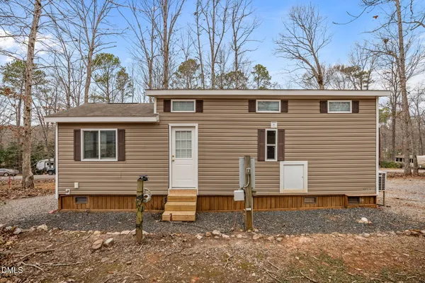 a view of a house with a yard and wooden fence