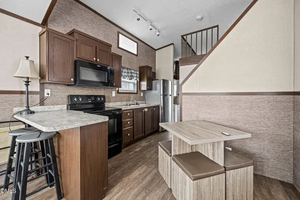 a kitchen with a sink cabinets and a window