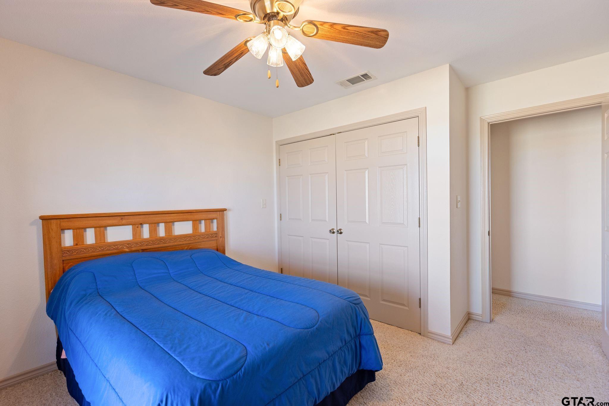 4 County Road 3566 Dike, TX 75437 - Photo 21 of 36 a bedroom with a bed and a chandelier