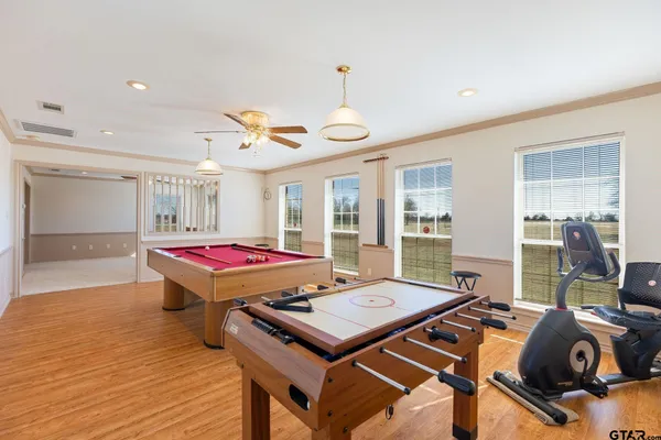 a kitchen with a refrigerator a oven a counter top space and a dining table