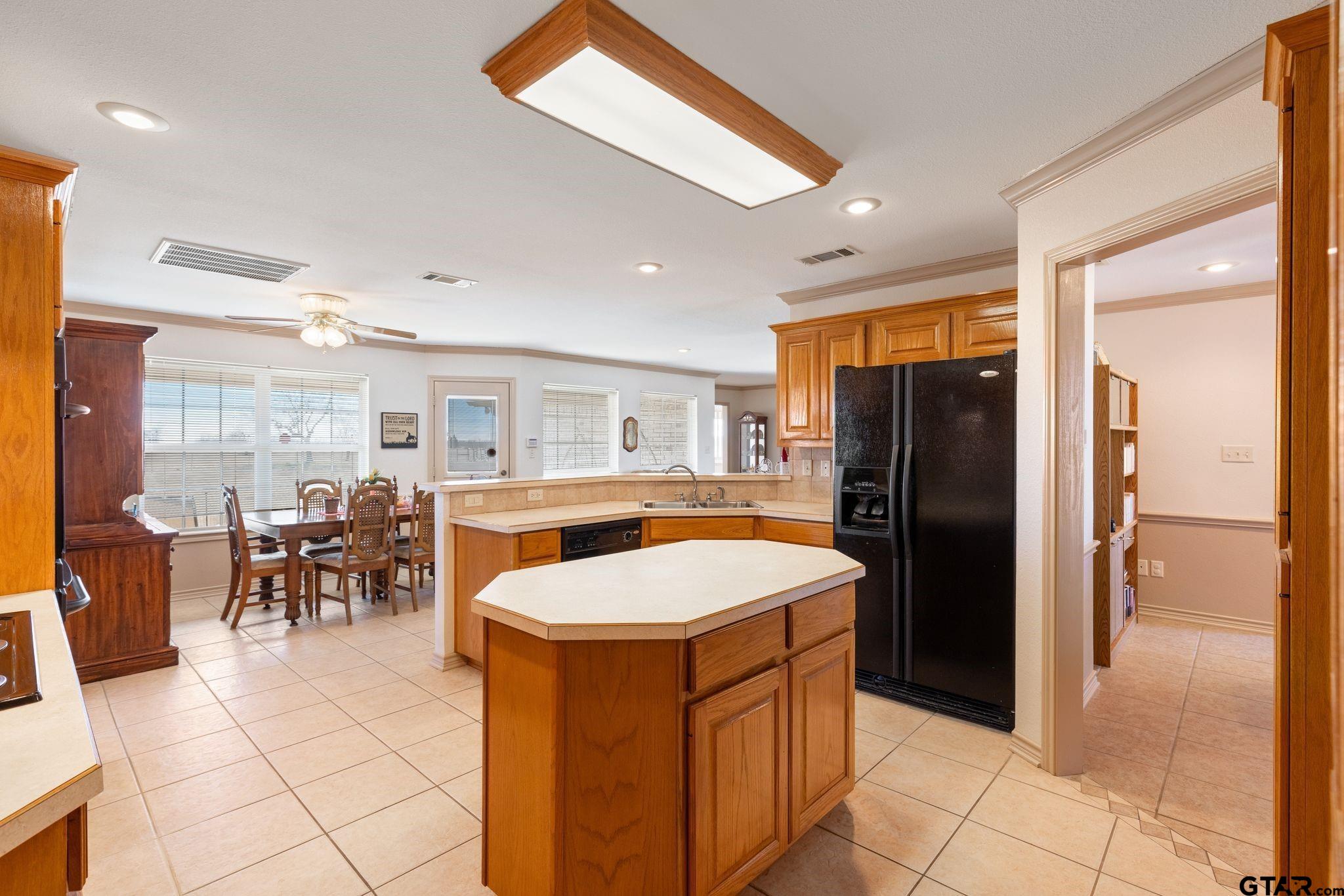 4 County Road 3566 Dike, TX 75437 - Photo 10 of 36 a kitchen with a refrigerator a oven a counter top space and a dining table