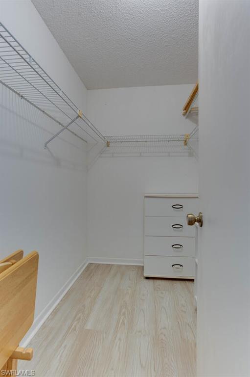 4351 27th Court Southwest, Unit 203 Naples, FL 34116 - Photo 16 of 34 Walk in closet featuring light hardwood / wood-style floors