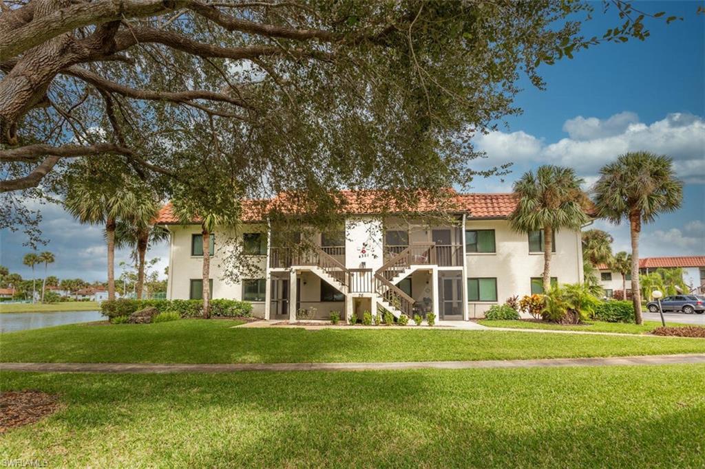 4351 27th Court Southwest, Unit 203 Naples, FL 34116 - Photo 2 of 34 View of building exterior with a water view