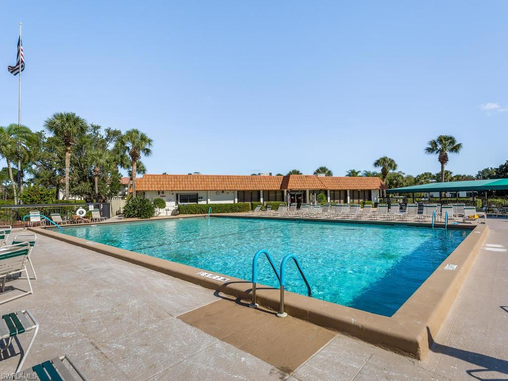4351 27th Court Southwest, Unit 203 Naples, FL 34116 - Photo 25 of 34 View of heated swimming pool featuring a patio area