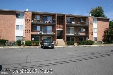 a view of building with car parked