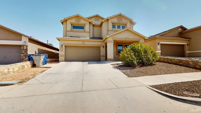 a view of multiple houses with a street