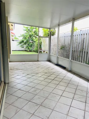 a view of a room with wooden floor and a chair