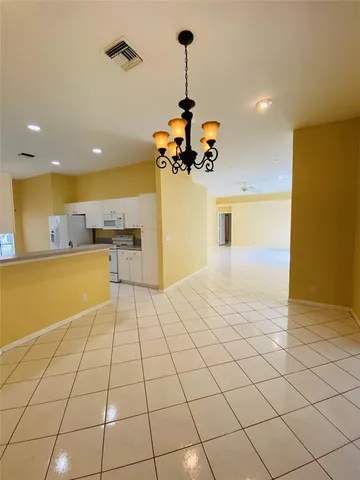 a view of a kitchen with a refrigerator and a microwave