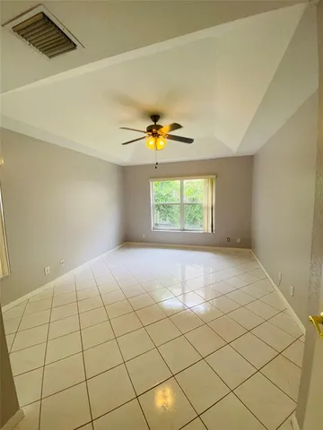 a view of an empty room and a window