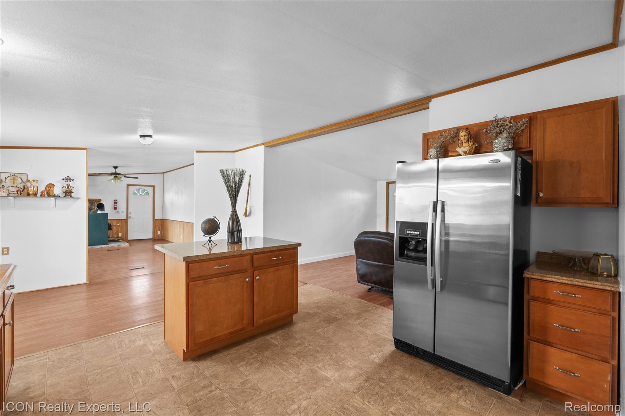 13620 Gilbert Road Allenton, MI 48002 - Photo 44 of 47 Kitchen featuring wood finish cabinetry, open floor plan, stainless steel fridge with ice dispenser, ornamental molding, and a ceiling fan