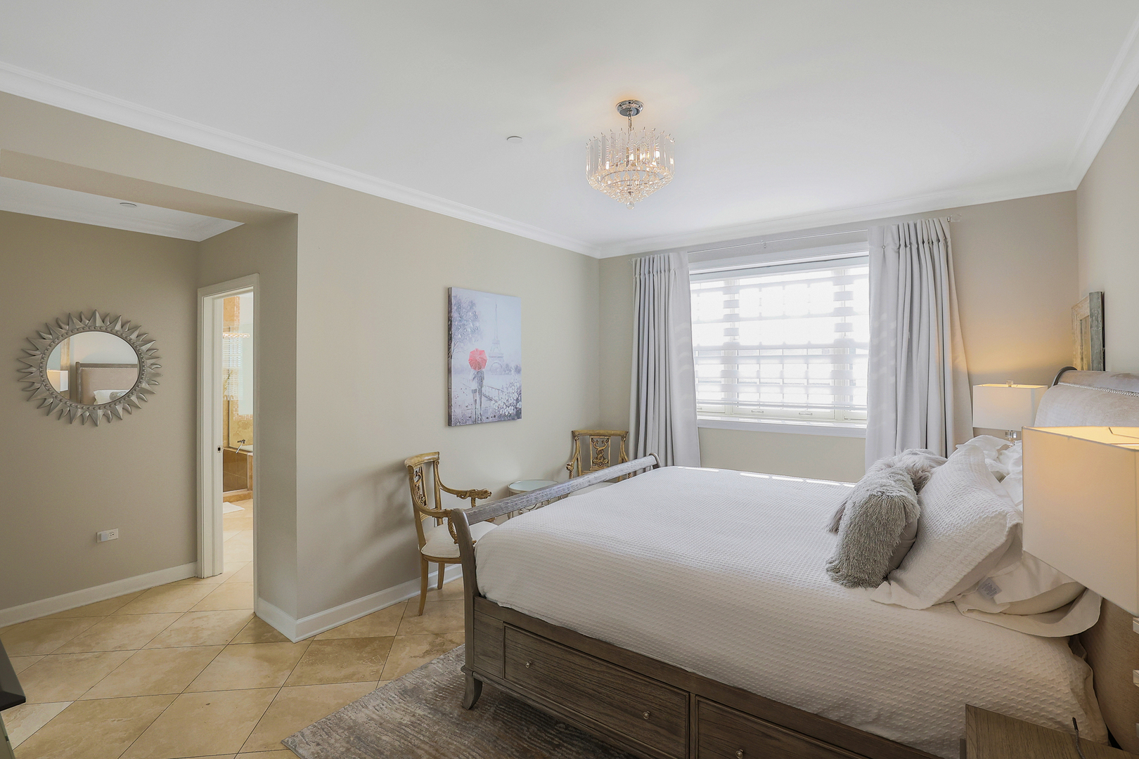 50 North Plum Grove Road, Unit 511E Palatine, IL 60067 - Photo 17 of 28 a bedroom with a bed and a chandelier