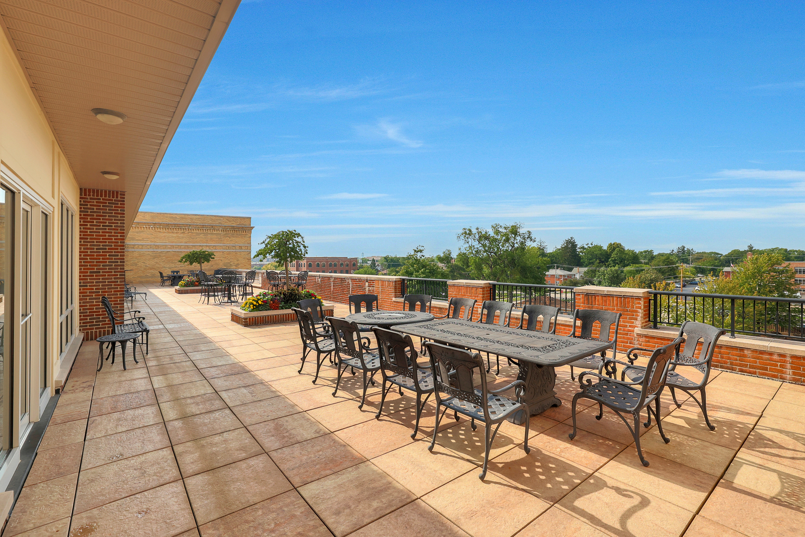 50 North Plum Grove Road, Unit 511E Palatine, IL 60067 - Photo 26 of 28 a view of a roof deck with table and chairs