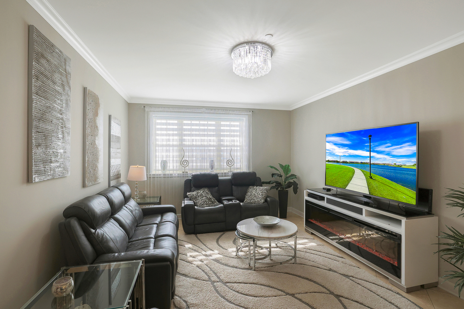 50 North Plum Grove Road, Unit 511E Palatine, IL 60067 - Photo 9 of 28 a living room with furniture a rug and a flat screen tv