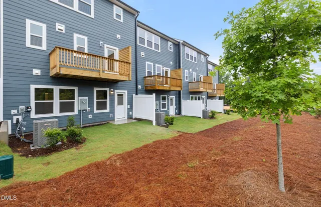 a view of a brick building next to a yard