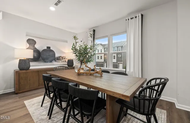 a view of a dining room with furniture and window