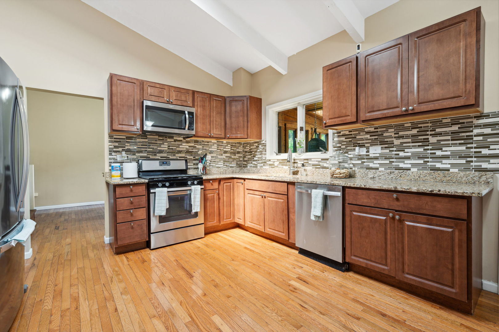 1741 Oak Lane Road Flossmoor, IL 60422 - Photo 7 of 30 a kitchen with stainless steel appliances granite countertop a stove top oven a sink dishwasher and a microwave oven with wooden floor