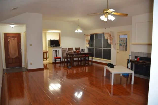 a view of a dining room with furniture wooden floor and chandelier