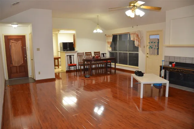 a view of a dining room with furniture and wooden floor