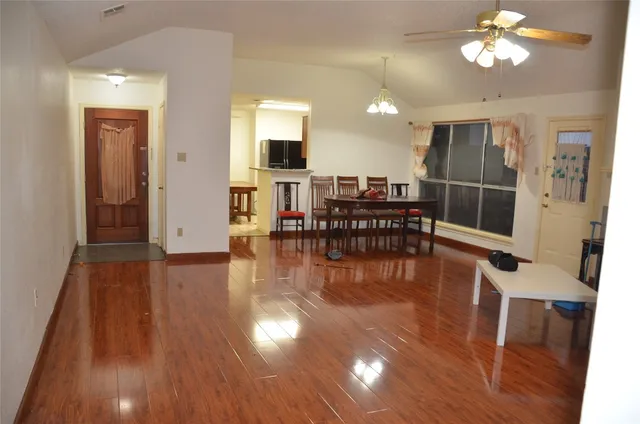 a view of a dining room with furniture and wooden floor