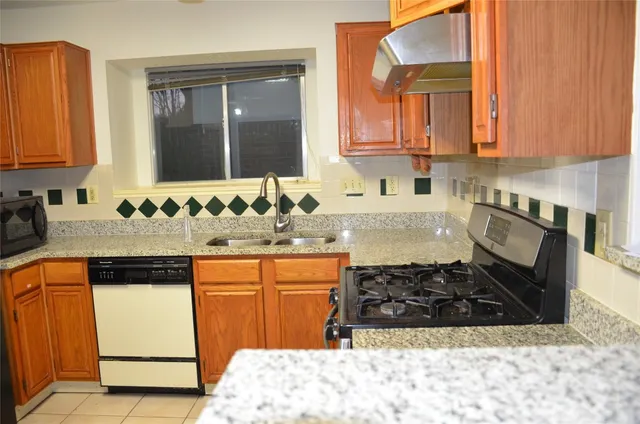 a kitchen with a sink stove and cabinets