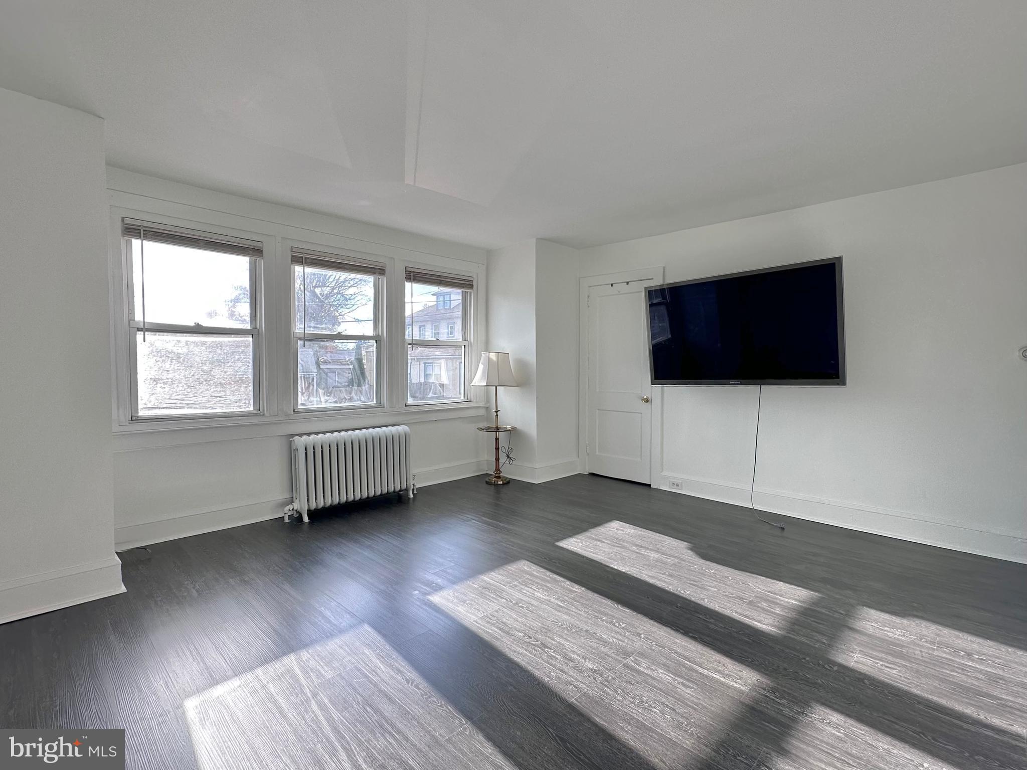 411 Burmont Road Drexel Hill, PA 19026 - Photo 1 of 28 a bedroom with a bed and a flat screen tv