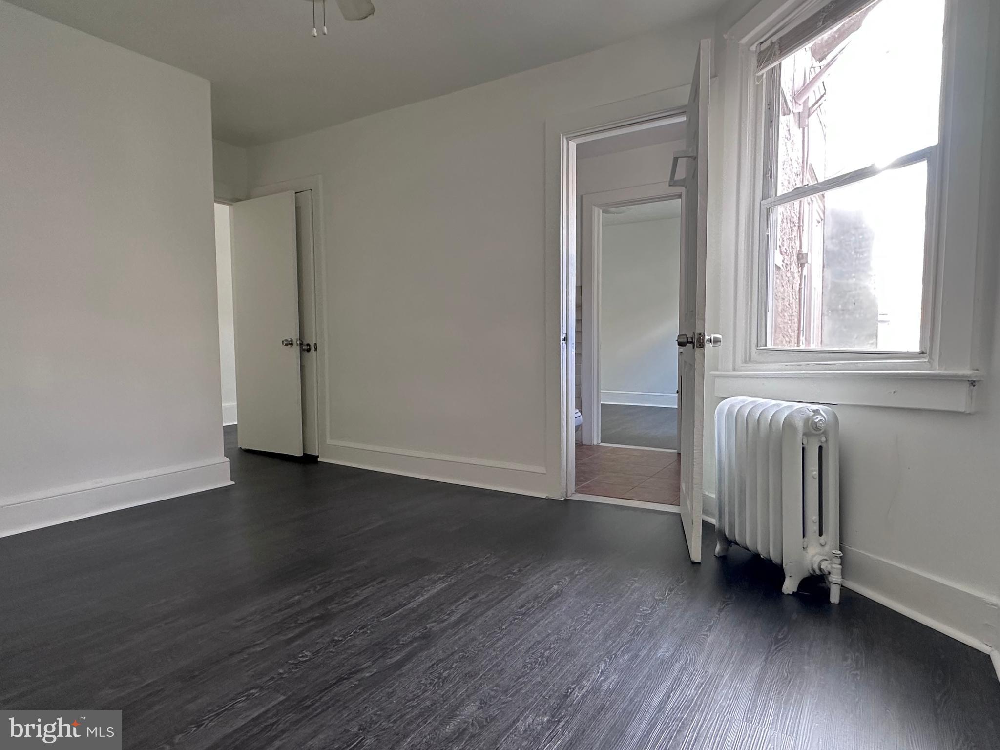 411 Burmont Road Drexel Hill, PA 19026 - Photo 11 of 28 an empty room with wooden floor and windows