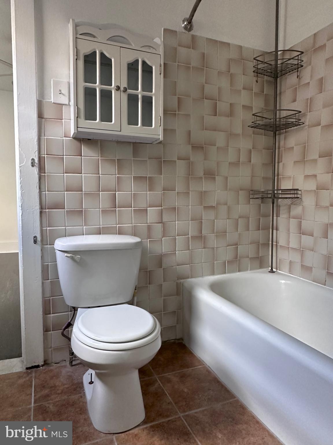 411 Burmont Road Drexel Hill, PA 19026 - Photo 15 of 28 a white toilet sitting next to a bathtub