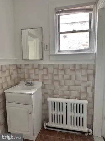 a view of a room with wooden floor and a bathroom