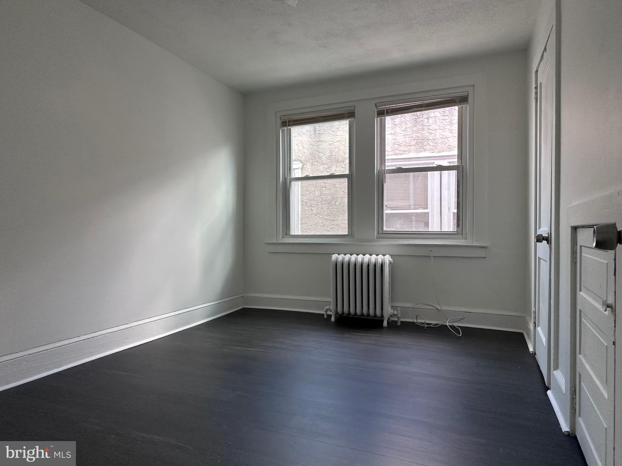 411 Burmont Road Drexel Hill, PA 19026 - Photo 20 of 28 an empty room with wooden floor and windows