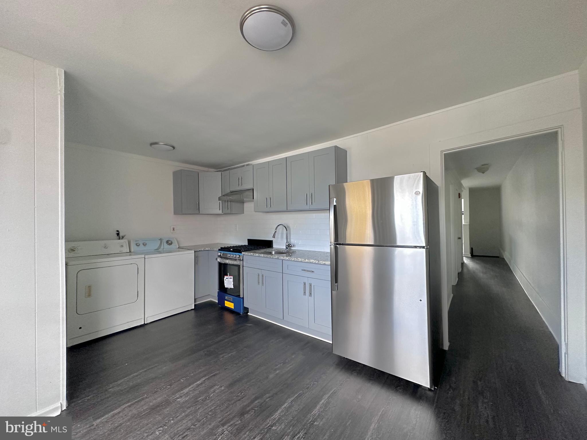 411 Burmont Road Drexel Hill, PA 19026 - Photo 22 of 28 a kitchen with white cabinets and white appliances