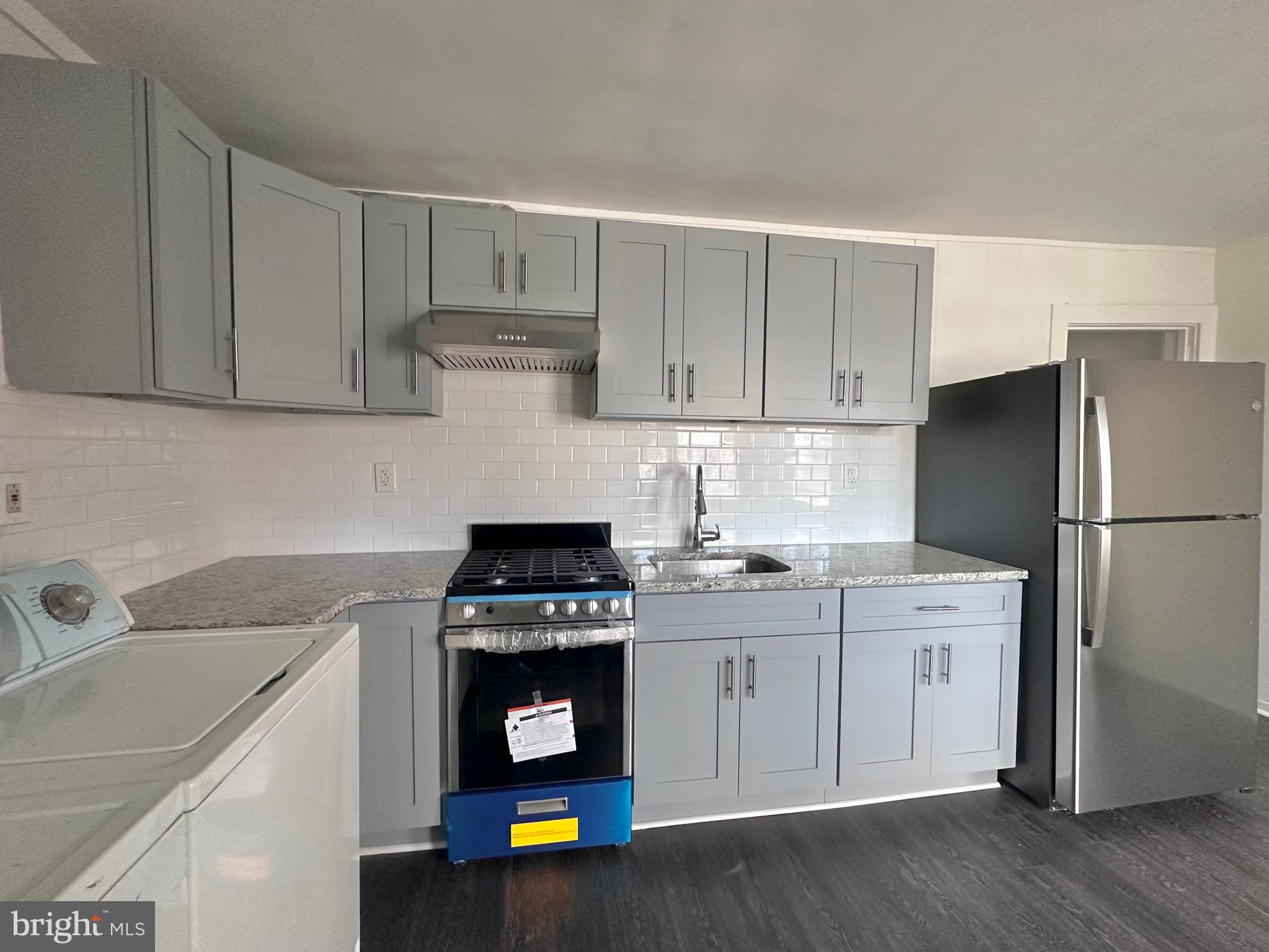 411 Burmont Road Drexel Hill, PA 19026 - Photo 23 of 28 a kitchen with a sink cabinets and appliances