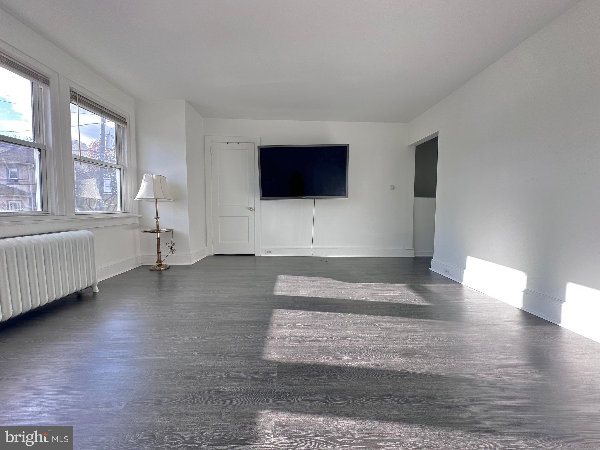 411 Burmont Road Drexel Hill, PA 19026 - Photo 5 of 28 a living room with furniture and a flat screen tv