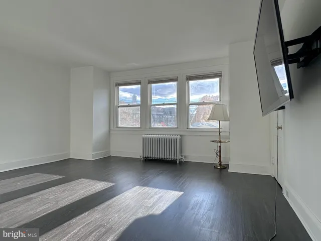 a view of an empty room and wooden floor