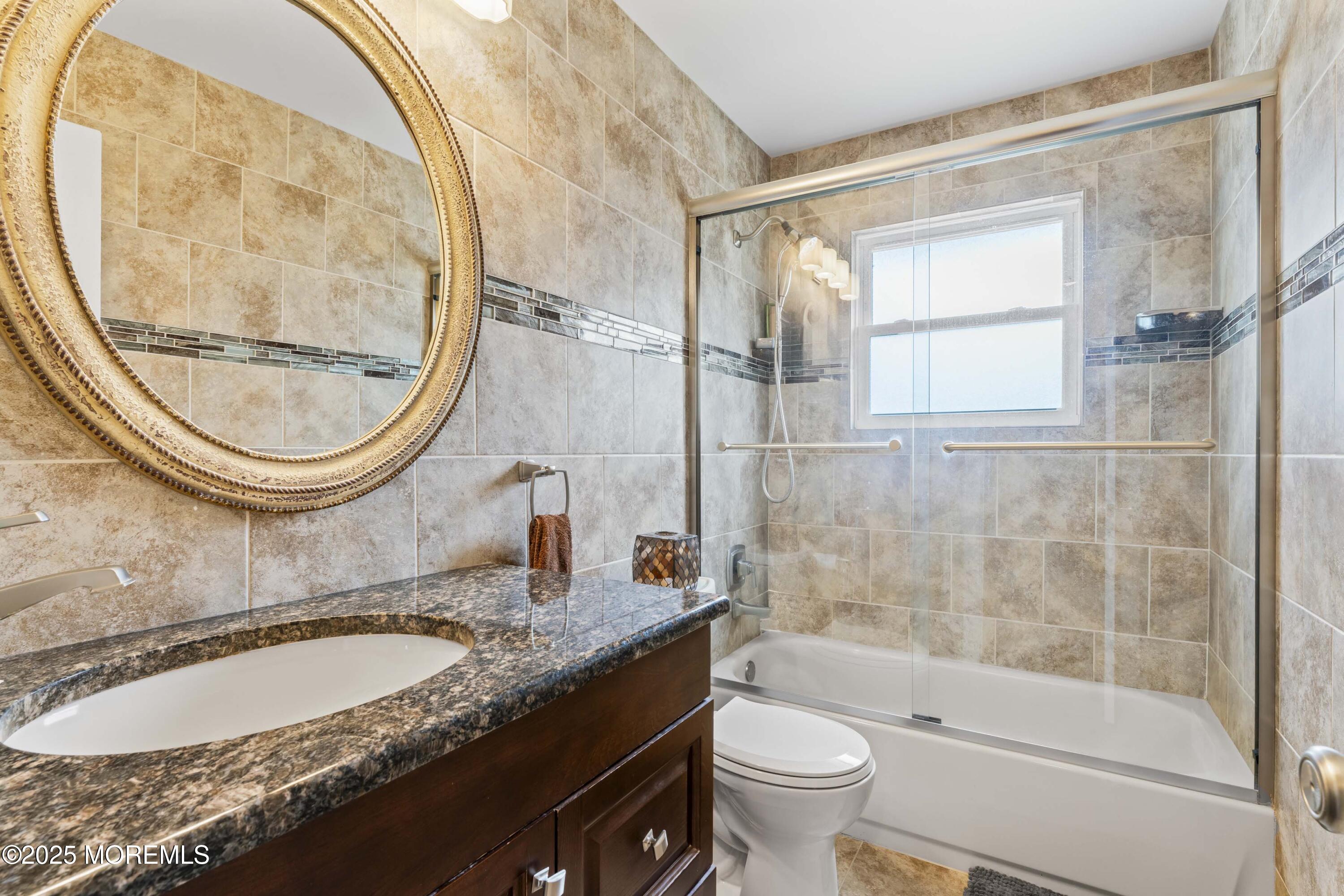 12 Nottingham Drive Howell, NJ 07731 - Photo 14 of 34 a bathroom with a granite countertop sink a toilet and a mirror