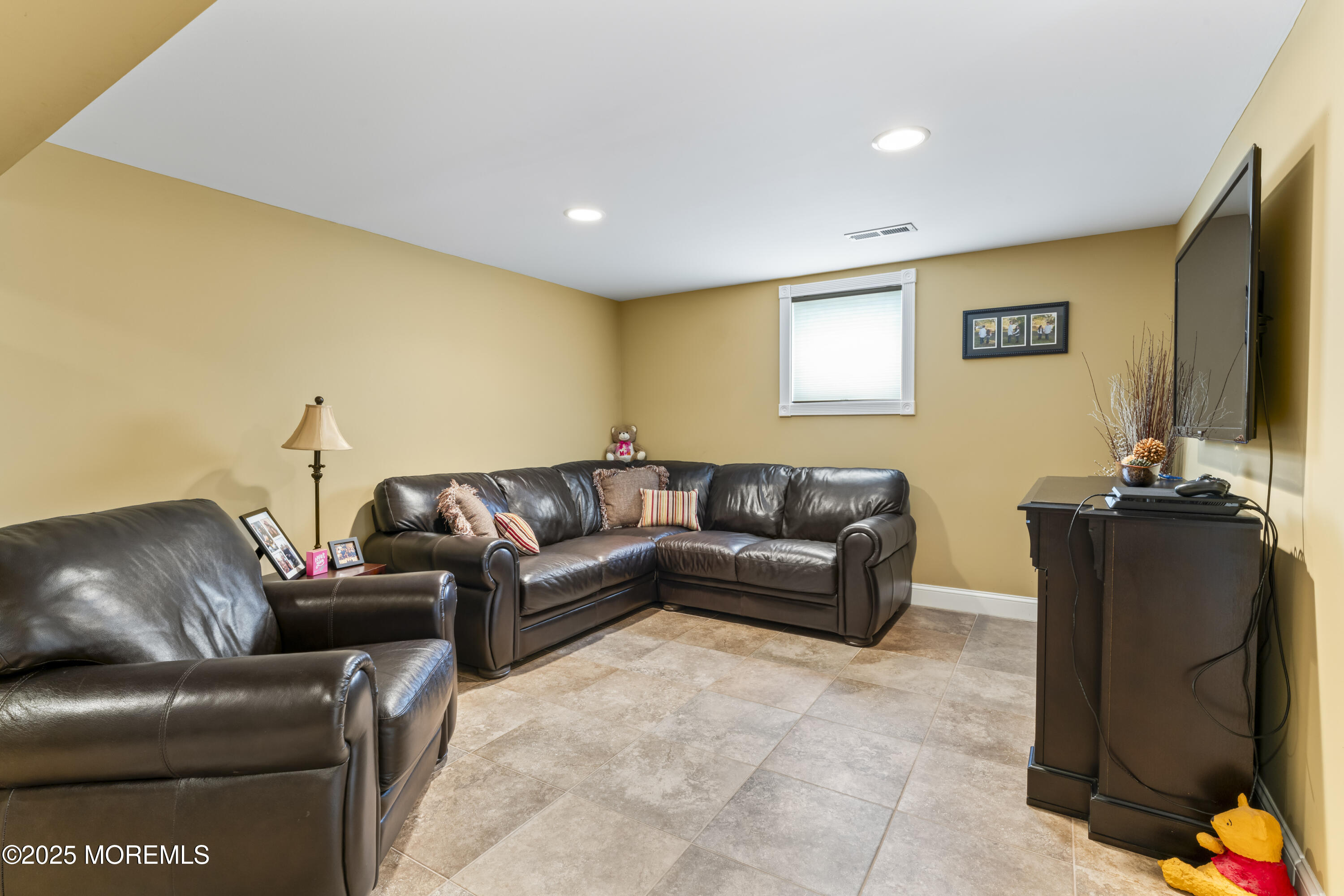 12 Nottingham Drive Howell, NJ 07731 - Photo 19 of 34 a living room with furniture and a flat screen tv
