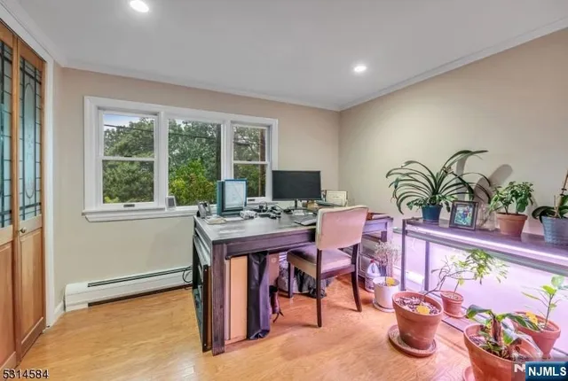a view of a house with a yard and large tree