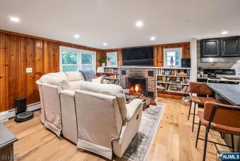 41 Bellot Road Ringwood, NJ 07456 - Photo 3 of 14 a living room with furniture a flat screen tv and a floor to ceiling window